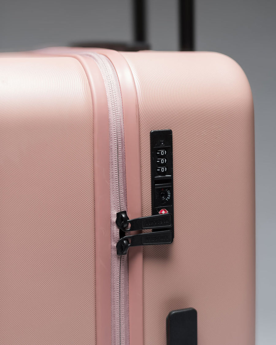 An assortment of Herschel Heritage Hardshell Carry On Luggage available in various colors.