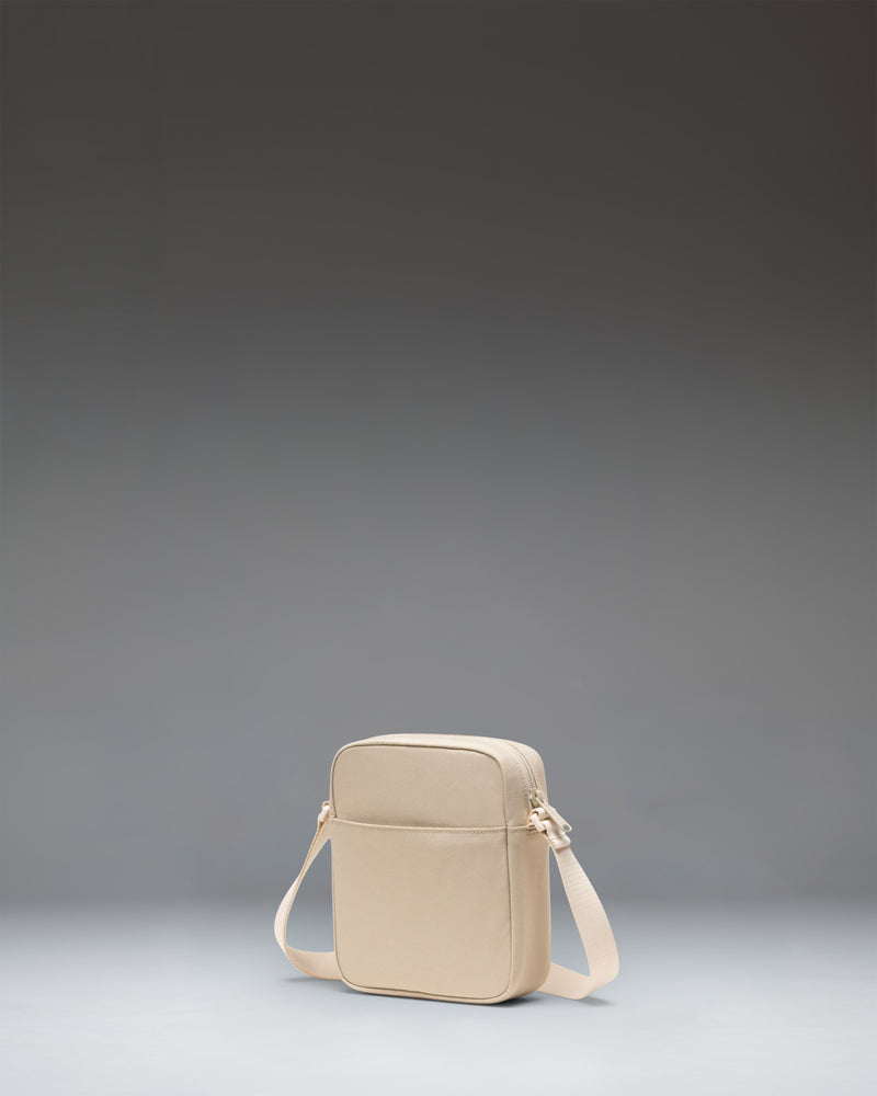 Herschel Heritage Crossbody bag in Eucalyptus green, showing the adjustable shoulder strap and signature diamond detail.