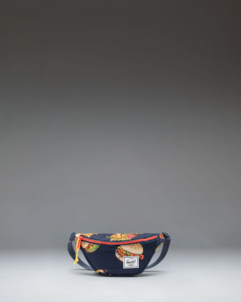 Herschel Heritage Hip Pack Little Herschel in navy blue and bright orange.