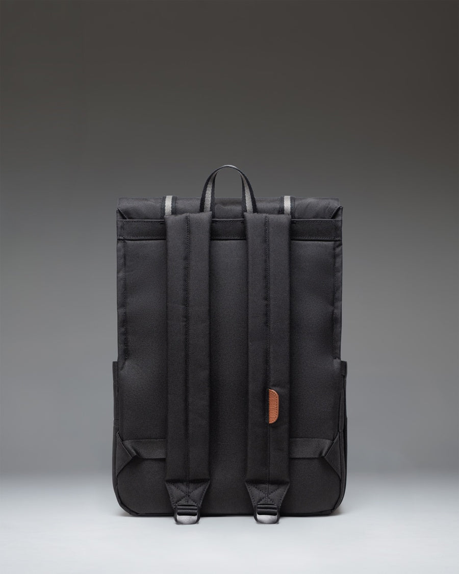 Herschel Survey Backpack in Patches Black, showing the back panel, padded shoulder straps, and a top haul handle.