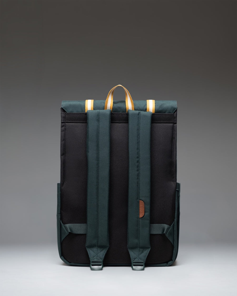 Herschel Survey Backpack in Patches Green Gables showing the front view with dual straps and a unique multi-shade green patchwork design.