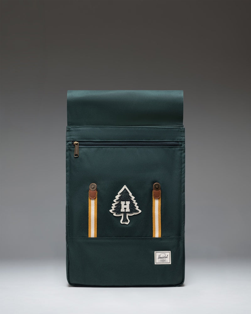 Herschel Survey Backpack in Patches Green Gables colorway, showcasing its clean, rectangular design and custom patch accents.