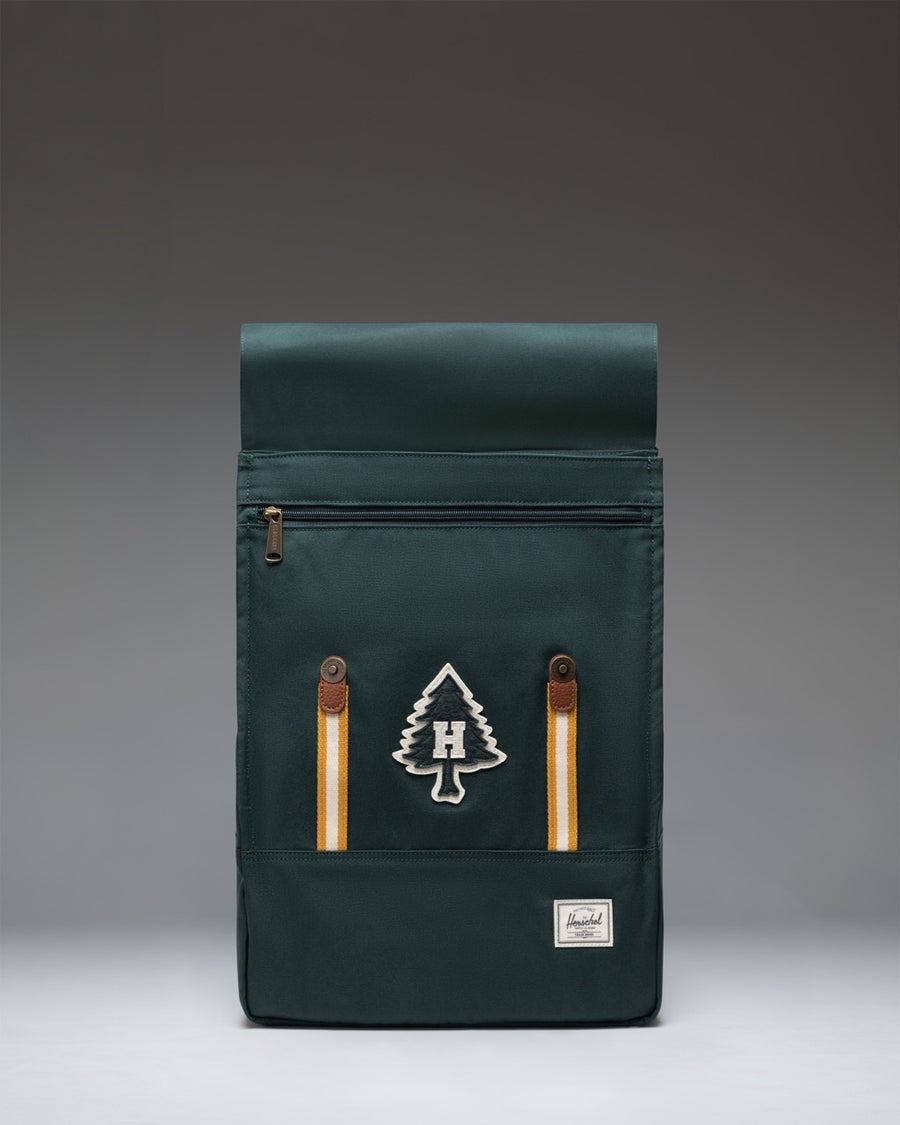 Herschel Survey Backpack in Patches Green Gables colorway, showcasing its clean, rectangular design and custom patch accents.