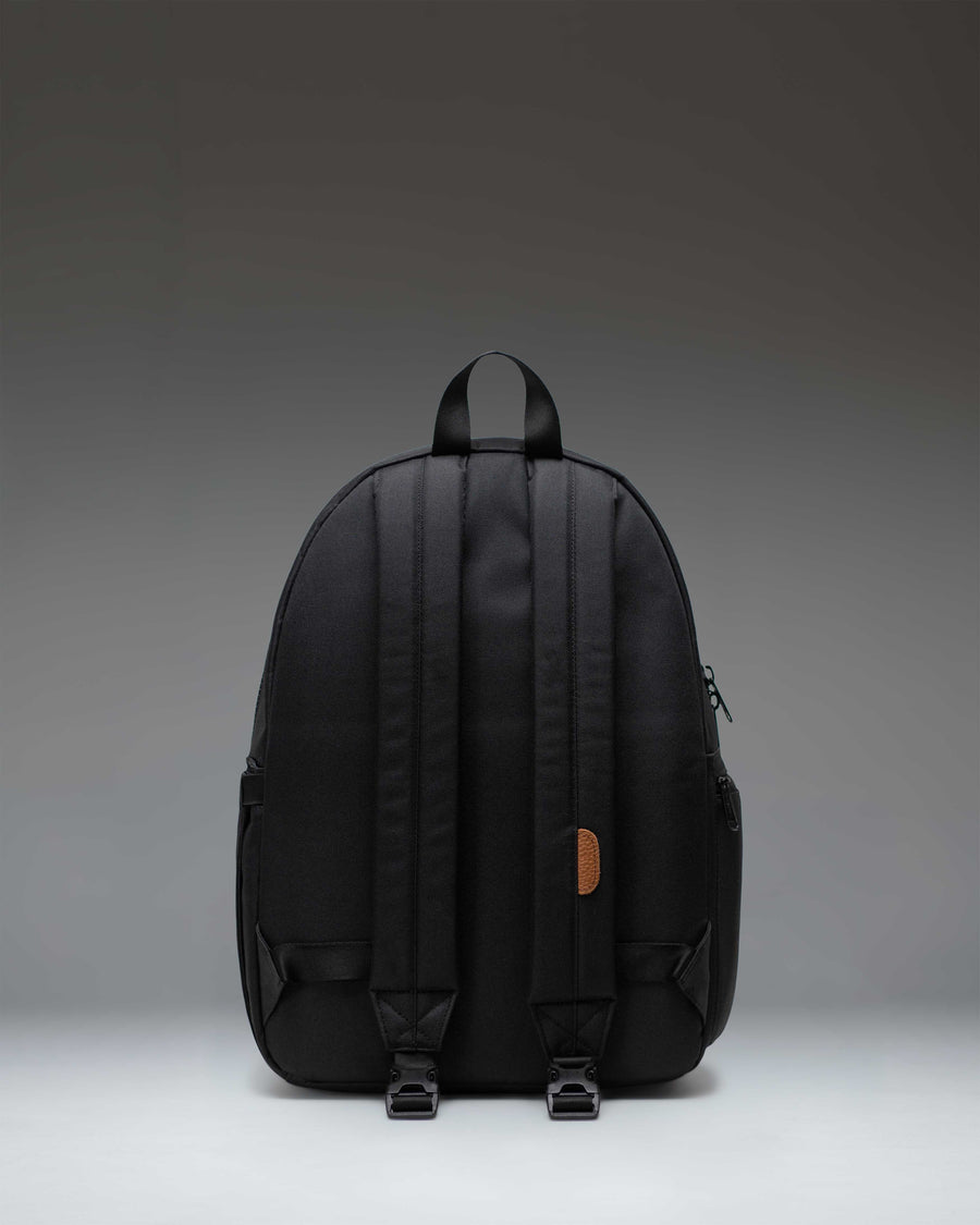 Black Herschel Supply Co. Settlement Backpack Diaper Bag showing the front view with zippered pockets and classic woven label.