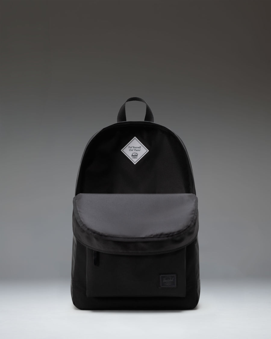 Herschel Supply Co. Heritage Backpack in classic black, showing the clean design, front pocket, and signature diamond accent.