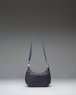 Herschel Supply Co. Yara Shoulder Bag in black showing the main compartment, zippered front pocket, and adjustable webbing strap.