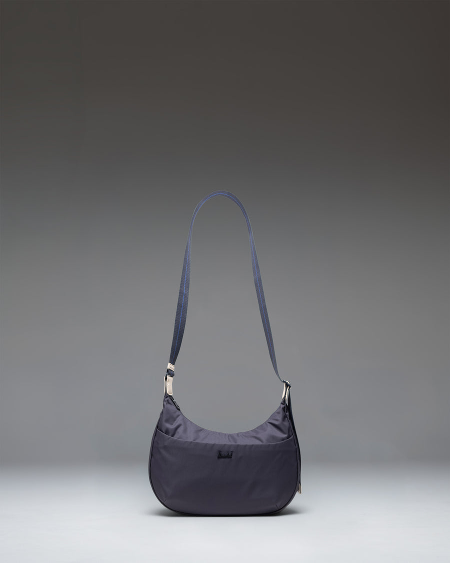 Herschel Supply Co. Yara Shoulder Bag in black showing the main compartment, zippered front pocket, and adjustable webbing strap.