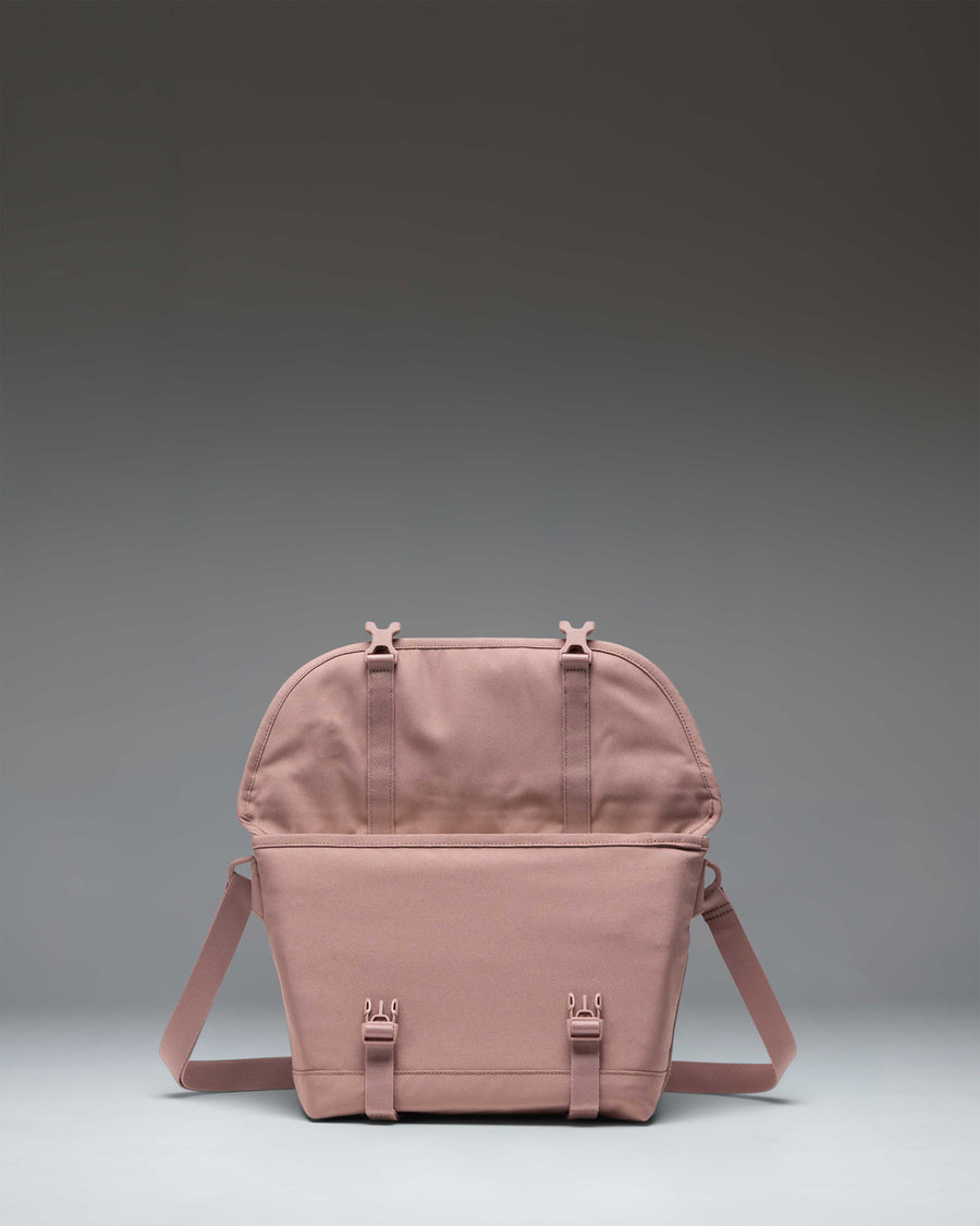 Herschel Supply Co. Cove Small Messenger bag in Ash Rose pink showing the front and side view.