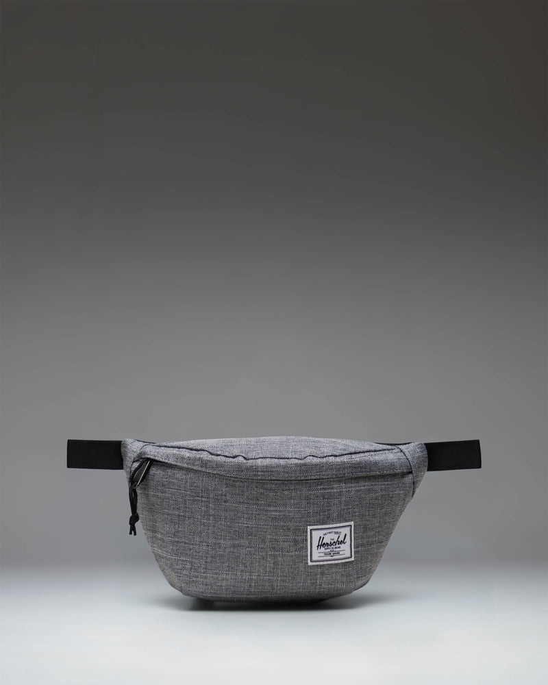 Herschel Classic Hip Pack in Raven Crosshatch grey. Front view showing main zipper compartment, adjustable strap, and classic woven label.