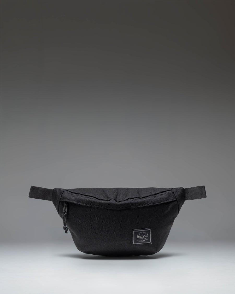 Herschel Classic Hip Pack in Black Tonal fabric, showing the front view with zipper closure and brand logo.