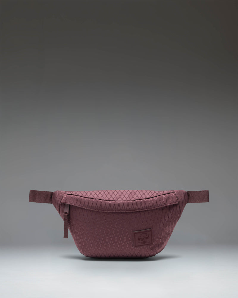 Herschel Supply Co. Herschel Classic Hip Pack in Huckleberry Diamond, a purple waist bag with a front pocket and adjustable strap.