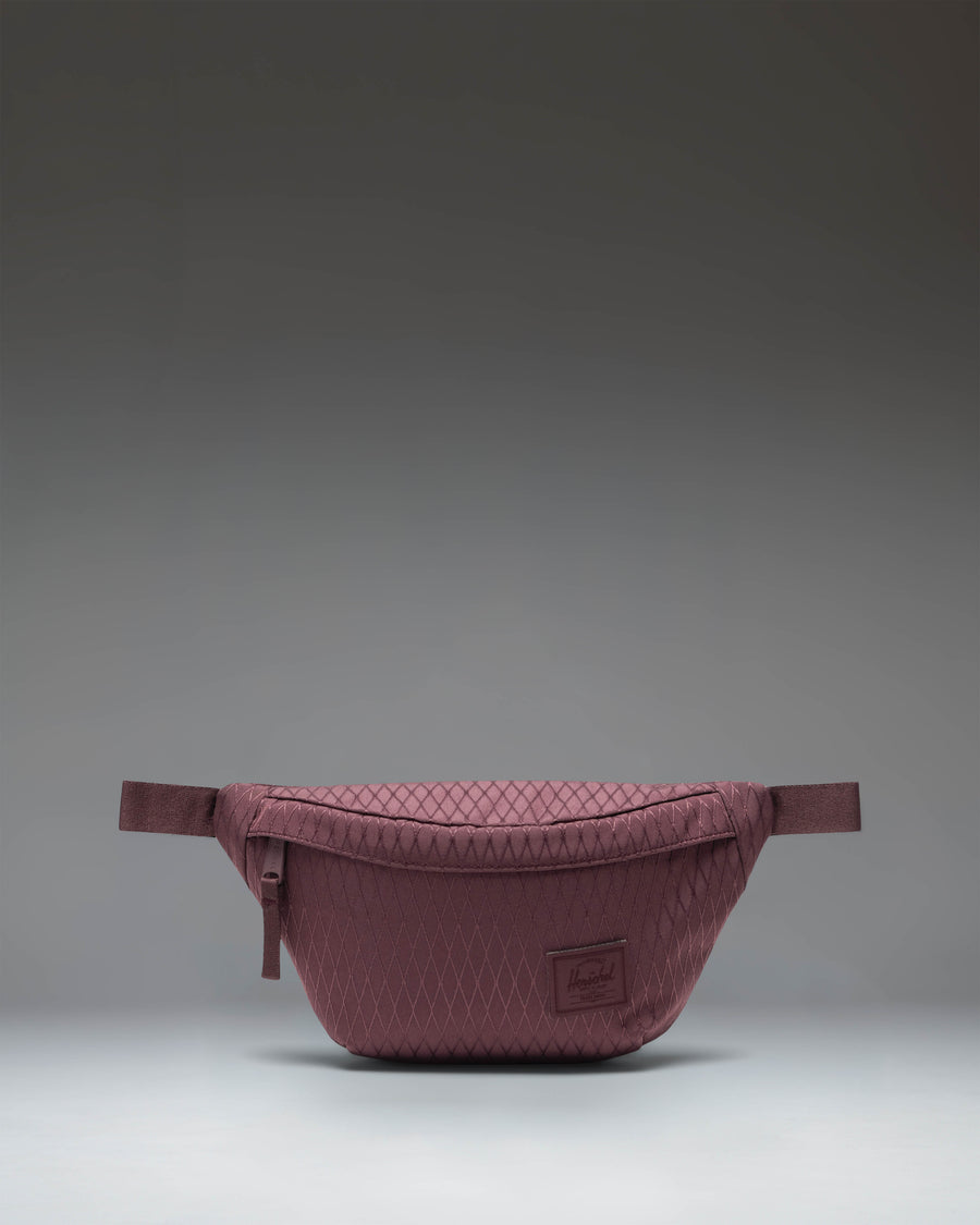 Herschel Supply Co. Herschel Classic Hip Pack in Huckleberry Diamond, a purple waist bag with a front pocket and adjustable strap.