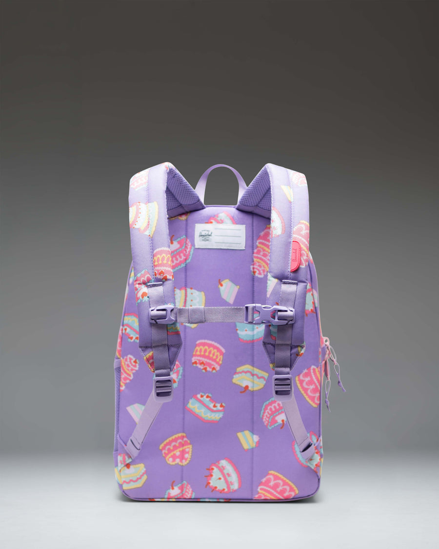 Herschel Heritage Youth Backpack in a playful cake print design featuring pink frosting and colorful sprinkles.