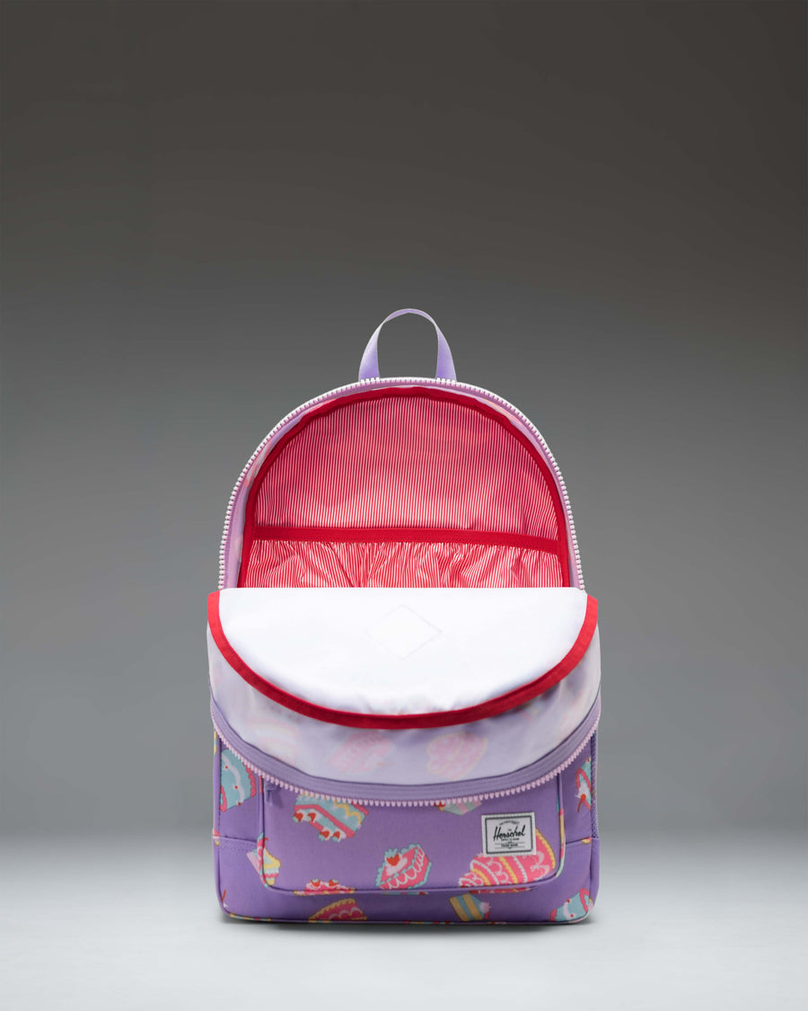Herschel Heritage Youth Backpack featuring a playful cake-themed print with a spacious main compartment and a front pocket.