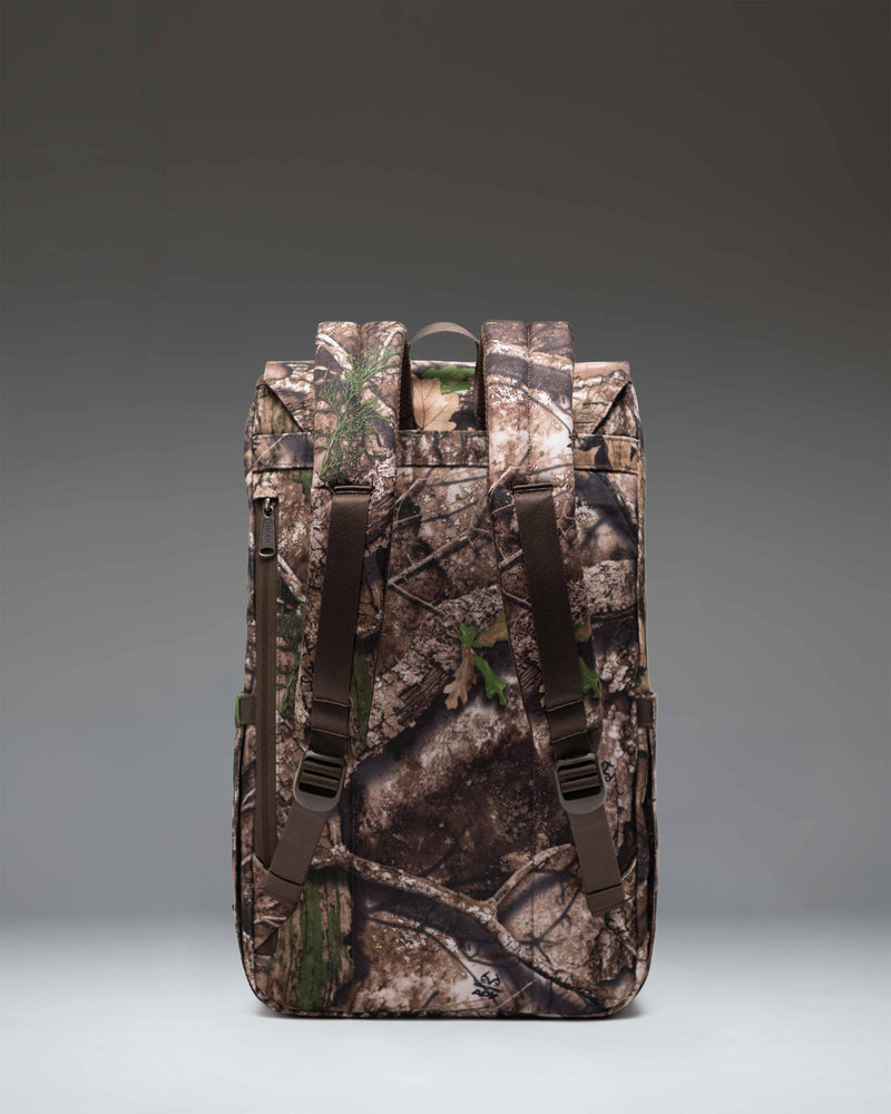 Herschel Supply Co. Realtree Retreat Backpack in Realtree APX Camo pattern, featuring a front pocket and dual strap closure.