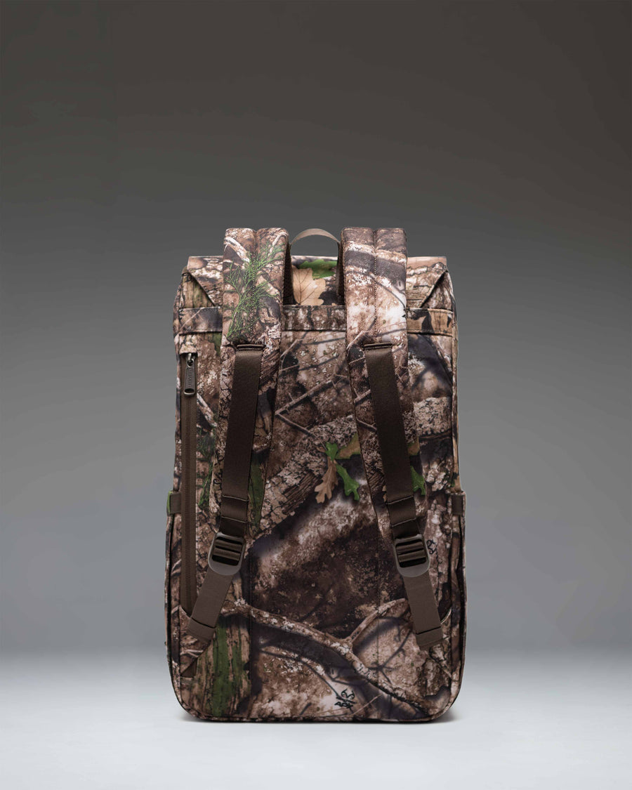 Herschel Supply Co. Realtree Retreat Backpack in Realtree APX Camo pattern, featuring a front pocket and dual strap closure.