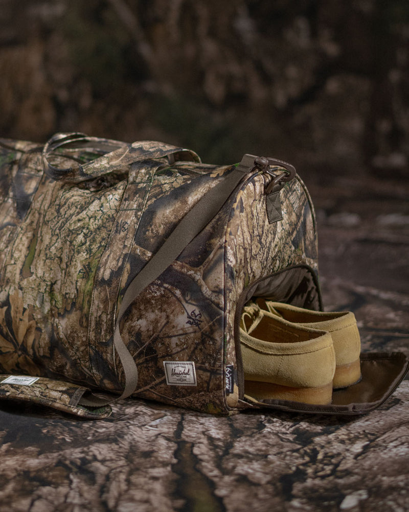 Herschel Supply Co. Realtree Novel Duffle Bag in Realtree APX Camo, showing all color options.