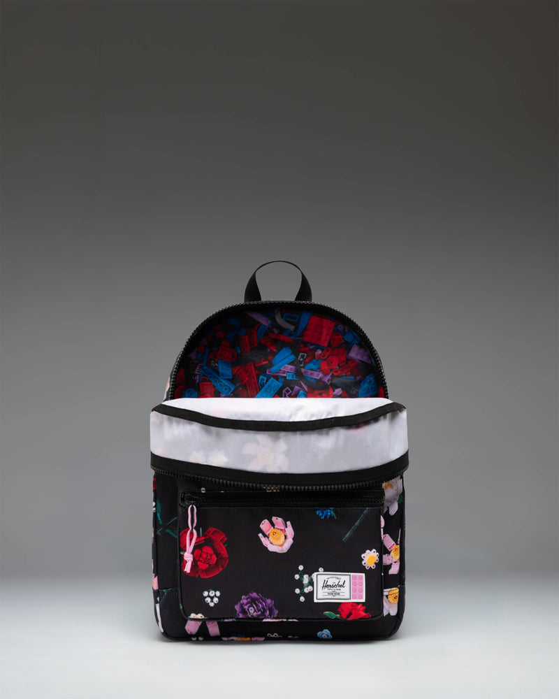 LEGO Herschel Heritage Kids Backpack in Falling Florals, a vibrant floral print pattern with signature LEGO brick details.