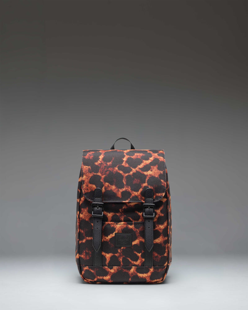 Herschel Retreat Mini Backpack in Digi Leopard print, featuring a clean cylindrical design with a flap closure and rubber strap details.