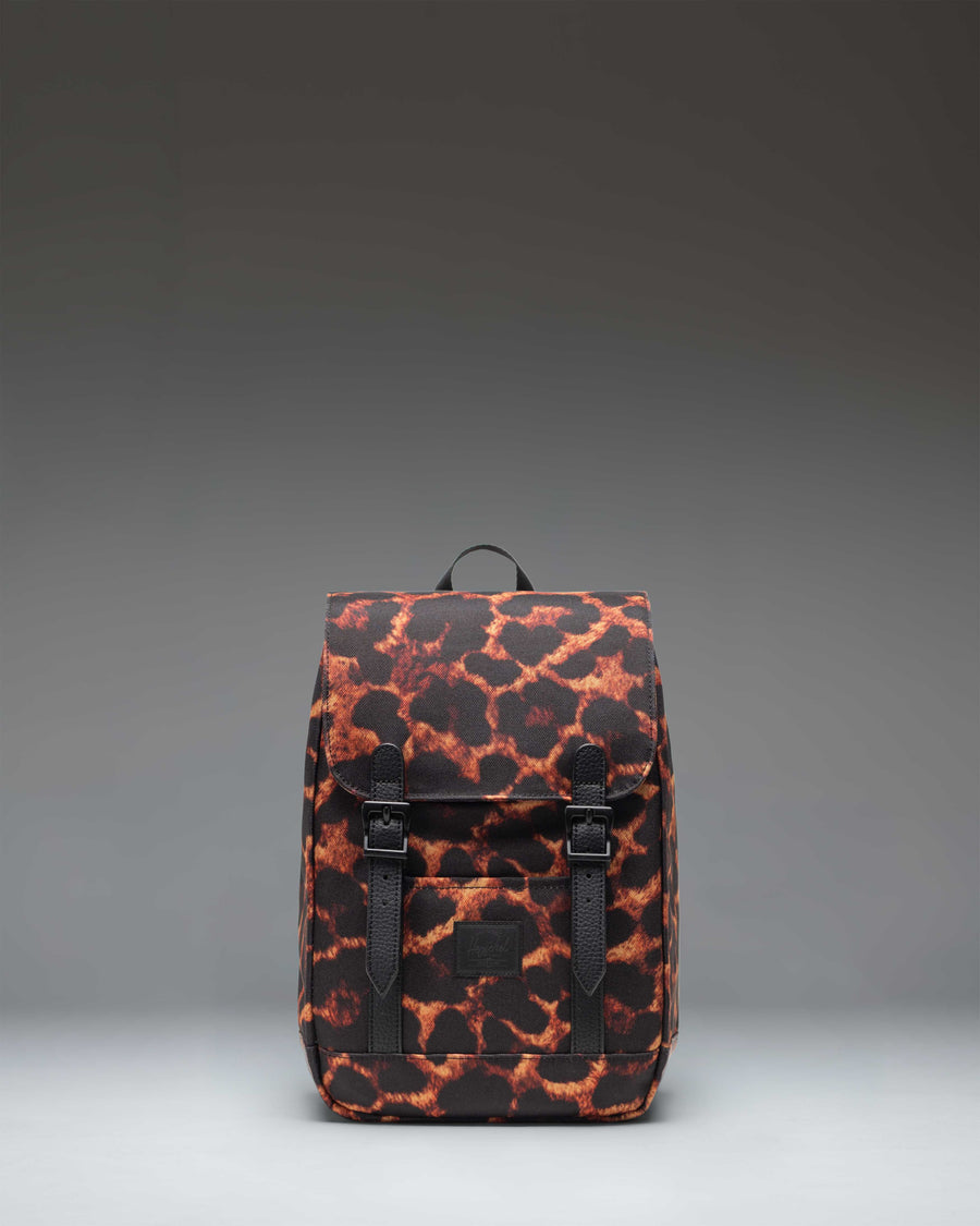 Herschel Retreat Mini Backpack in Digi Leopard print, featuring a clean cylindrical design with a flap closure and rubber strap details.