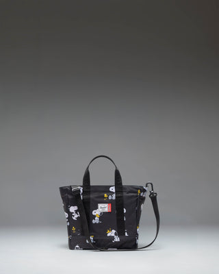 Black Peanuts Herschel Heritage Small Tote bag featuring a Snoopy and Woodstock graphic print on the front pocket.