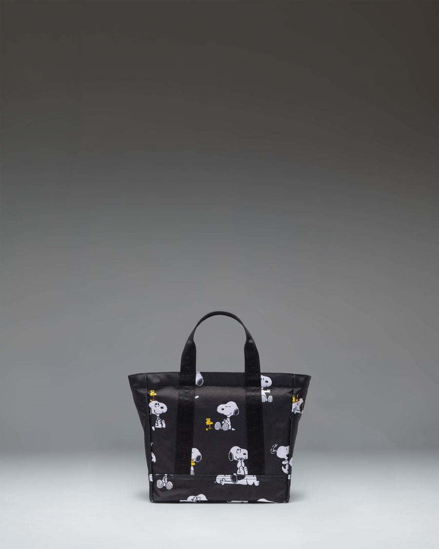 Herschel Supply Co. x Peanuts Heritage Small Tote bag in Snoopy and Woodstock Black featuring an all-over character print.