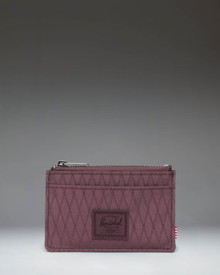 Herschel Supply Co Oscar Cardholder in Huckleberry Diamond, a slim wallet featuring a textured deep purple color with multiple card slots.