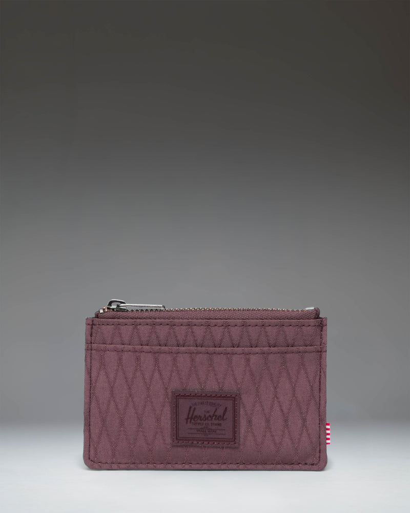 Herschel Supply Co Oscar Cardholder in Huckleberry Diamond, a slim wallet featuring a textured deep purple color with multiple card slots.