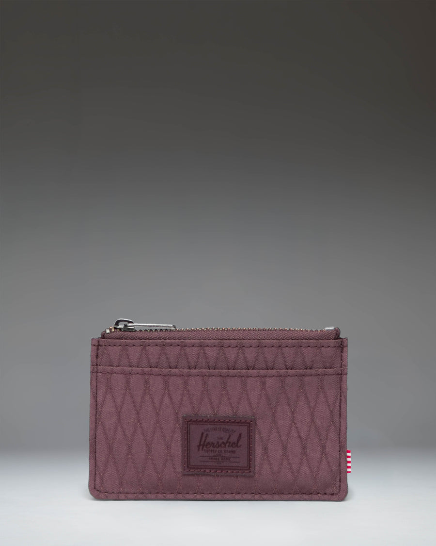 Herschel Supply Co Oscar Cardholder in Huckleberry Diamond, a slim wallet featuring a textured deep purple color with multiple card slots.