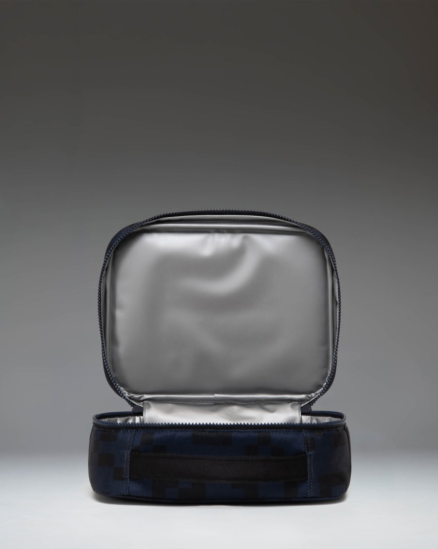 Herschel Supply Co. Minecraft Pop Quiz Enderman lunch box, lifestyle view showing its compact design and pixelated print.