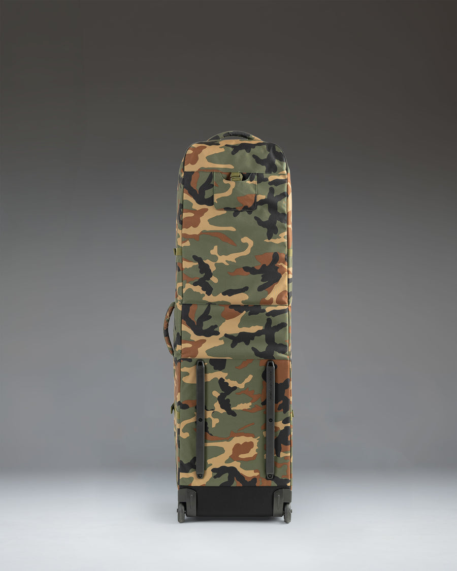 Herschel Heritage Golf Travel Wheelie Bag in Woodland Camo lifestyle view.