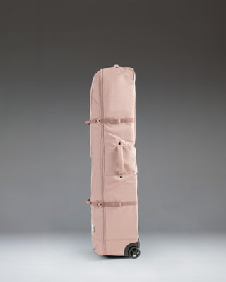 Herschel Heritage Golf Travel Wheelie Bag in Ash Rose, a durable rolling travel bag designed for protecting golf clubs and gear.