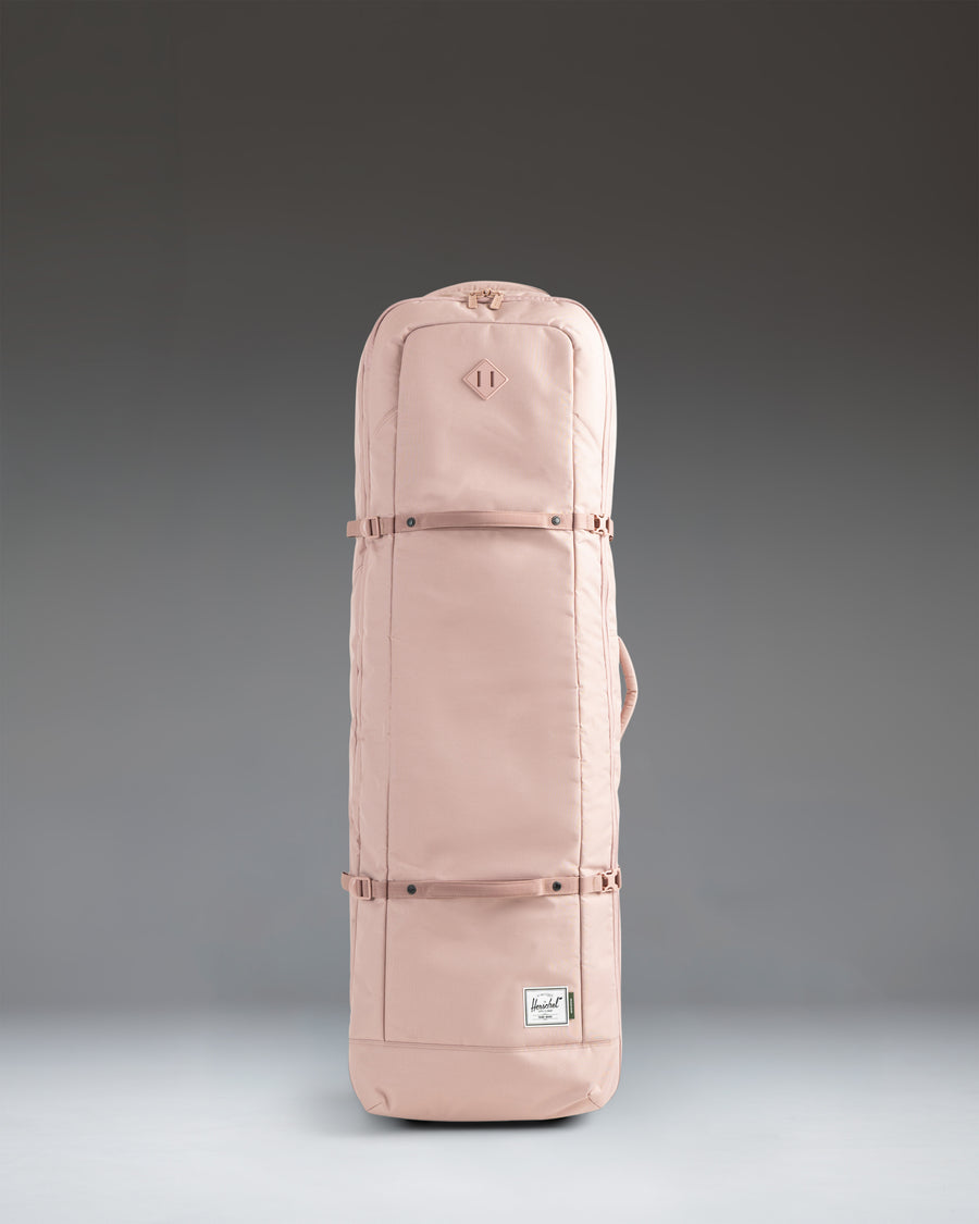 Herschel Heritage Golf Travel Wheelie Bag in Ash Rose pink, showcasing its durable exterior, wheels, and handles.