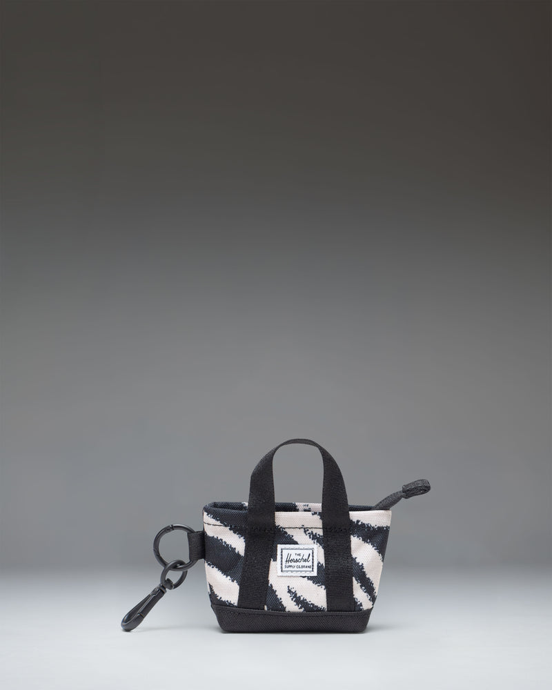Herschel Supply Co. Herschel Heritage Tote Bag Charm in a striking black and white Zebra print design, featuring a convenient clip attachment.