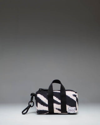 Herschel Novel Duffle Bag Charm in black and white zebra print with a top handle, zippered main compartment, and signature shoe compartment.