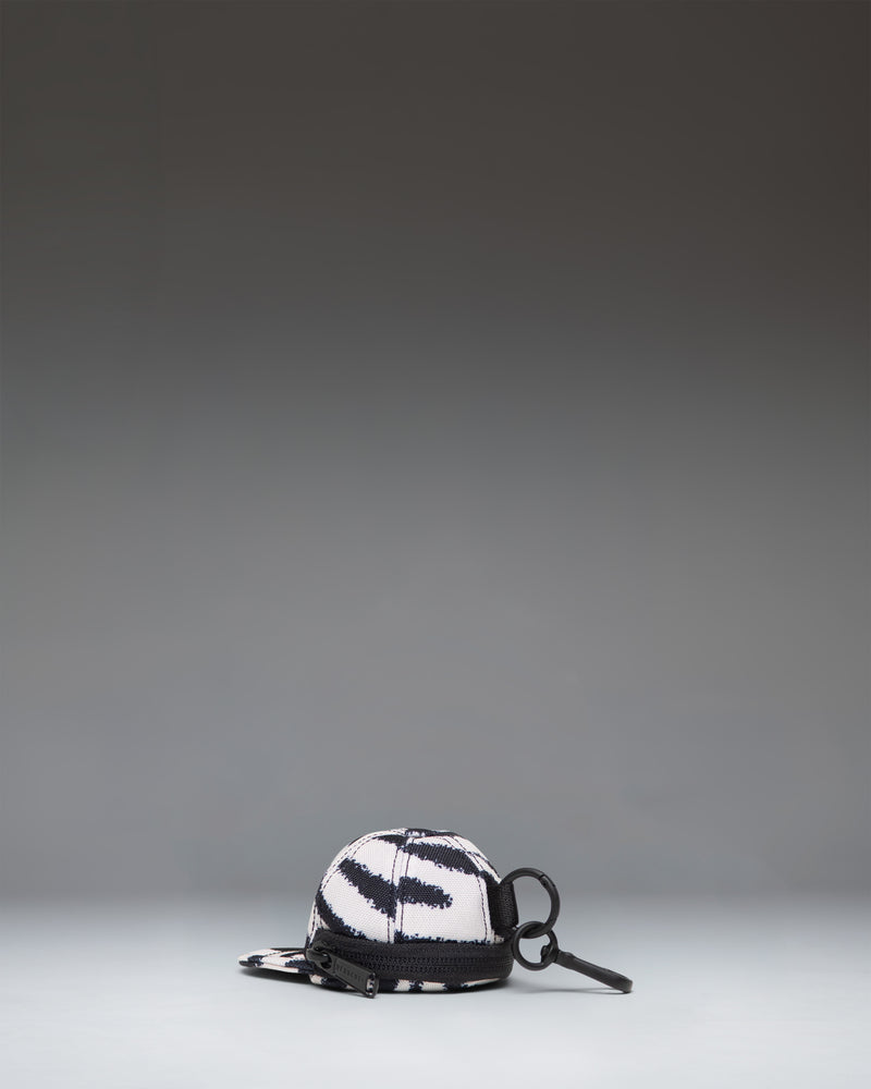 Herschel Supply Co. Sylas Classic Cap Bag Charm in black and white zebra print.