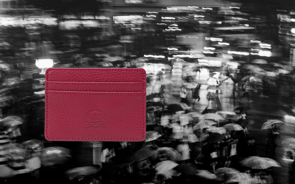 Herschel Supply Co. Charlie Cardholder in Cherry Red vegan leather, showing the front slots and classic woven label.