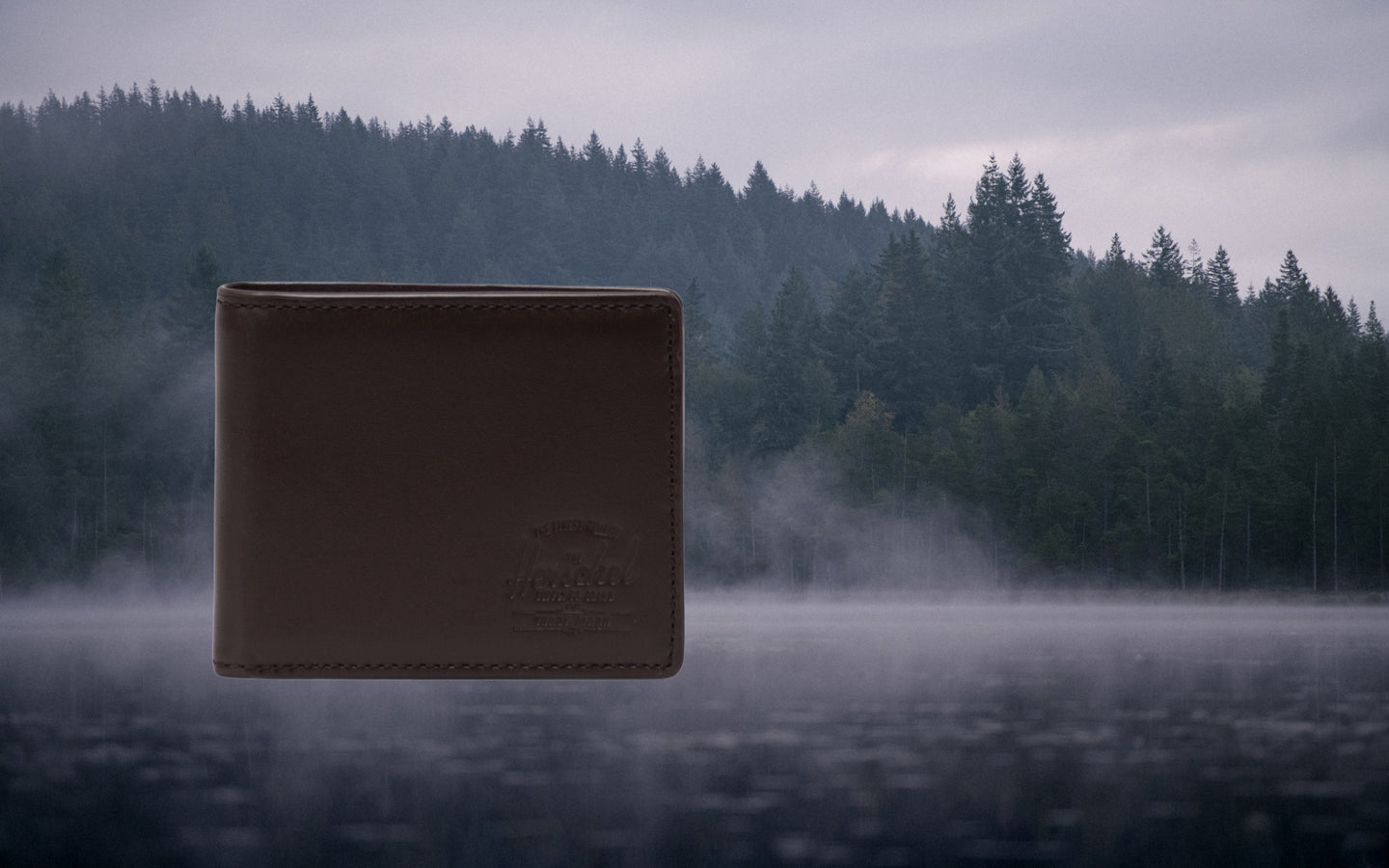 Brown leather Herschel Supply Co. Hank Wallet featured in an ecommerce hero banner image.