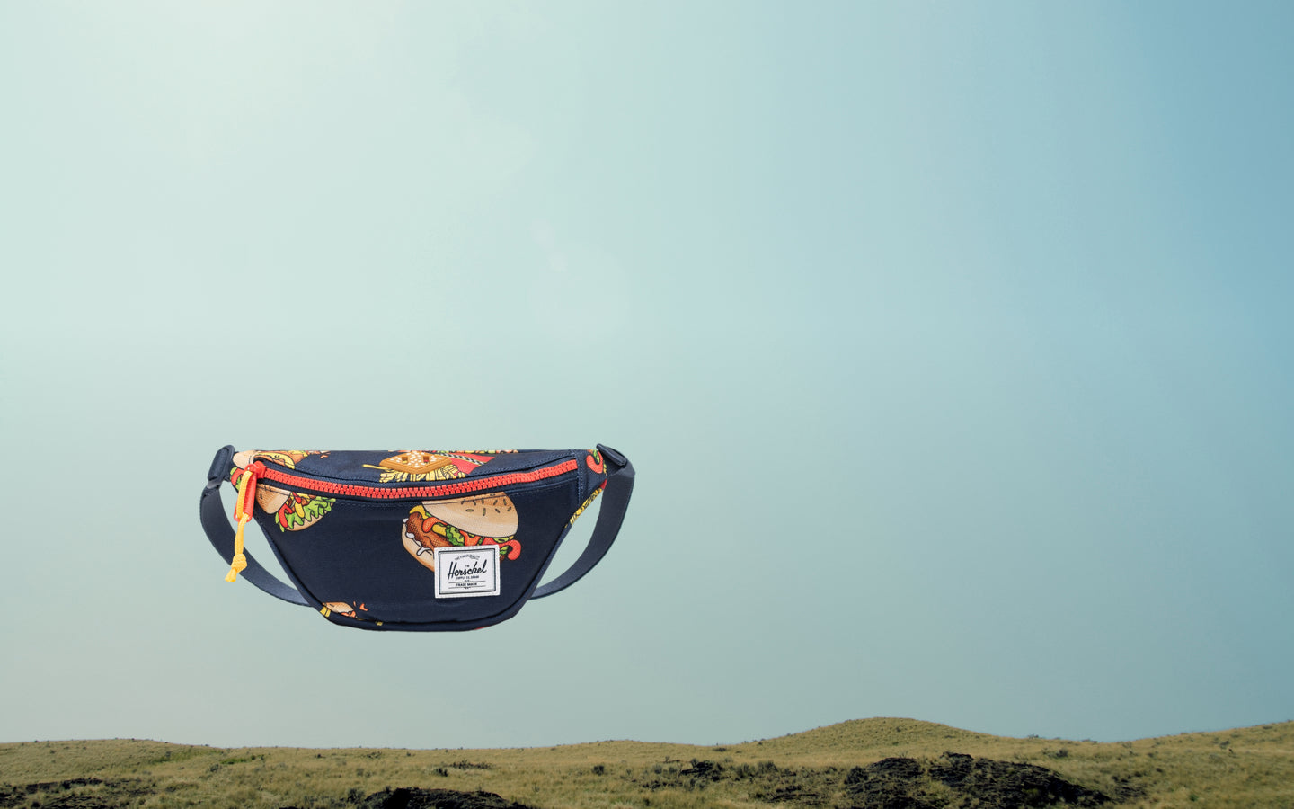 Herschel Heritage Hip Pack Little Herschel in dark blue and red-orange.