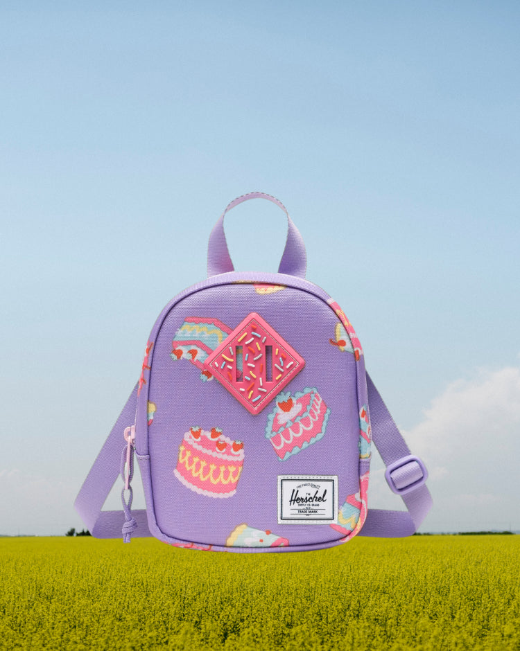 Herschel Heritage Crossbody Little Herschel bag in Cakes colorway, showing the front view with classic logo label.