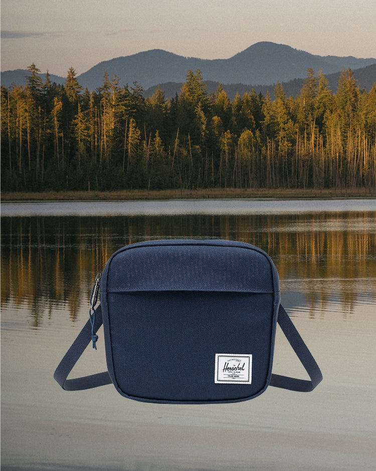 Herschel Supply Co. Classic Crossbody bag in navy blue, shown from the front.