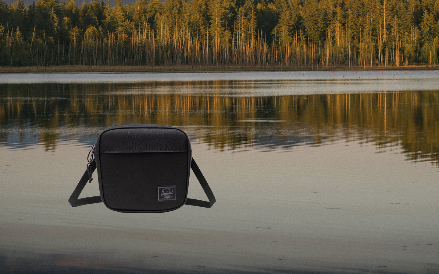 Herschel Supply Co. Herschel Classic Crossbody bag in Black Tonal, shown from the front on a desktop view.