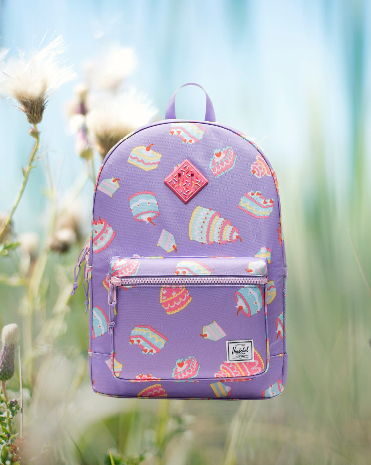 Herschel Heritage Youth Backpack in Cakes, featuring a colorful cake pattern print.