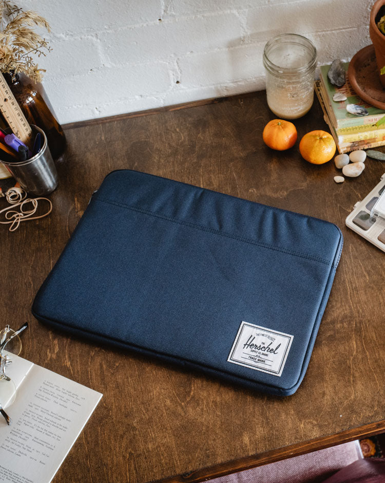 Herschel Supply Co. Anchor laptop sleeve for 15-16 inch devices in a classic solid navy blue colorway.