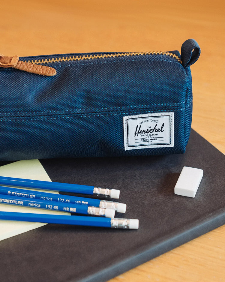 Herschel Supply Co. Settlement Pencil Case in Navy blue featuring a classic zippered design with a side carrying handle and signature woven label.
