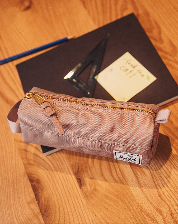 Herschel Supply Co. Settlement Pencil Case in Ash Rose pink, featuring a classic zippered design with a signature woven label.