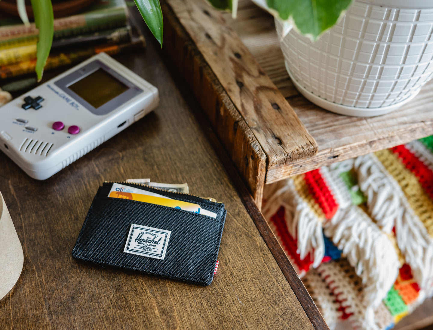 Black Herschel Supply Co. Oscar Cardholder featuring multiple card slots and a top-access storage sleeve with signature striped liner.
