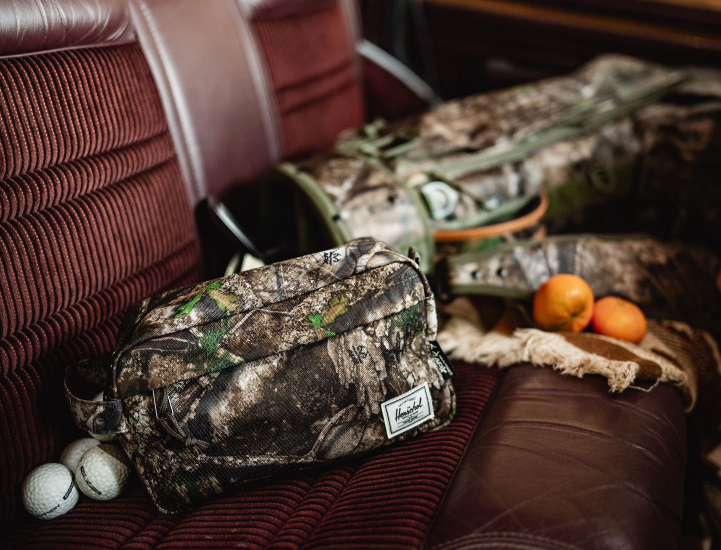 Herschel Supply Co. Realtree Chapter Travel Kit in Realtree APX Camo featuring a side carrying handle and front zippered pocket.