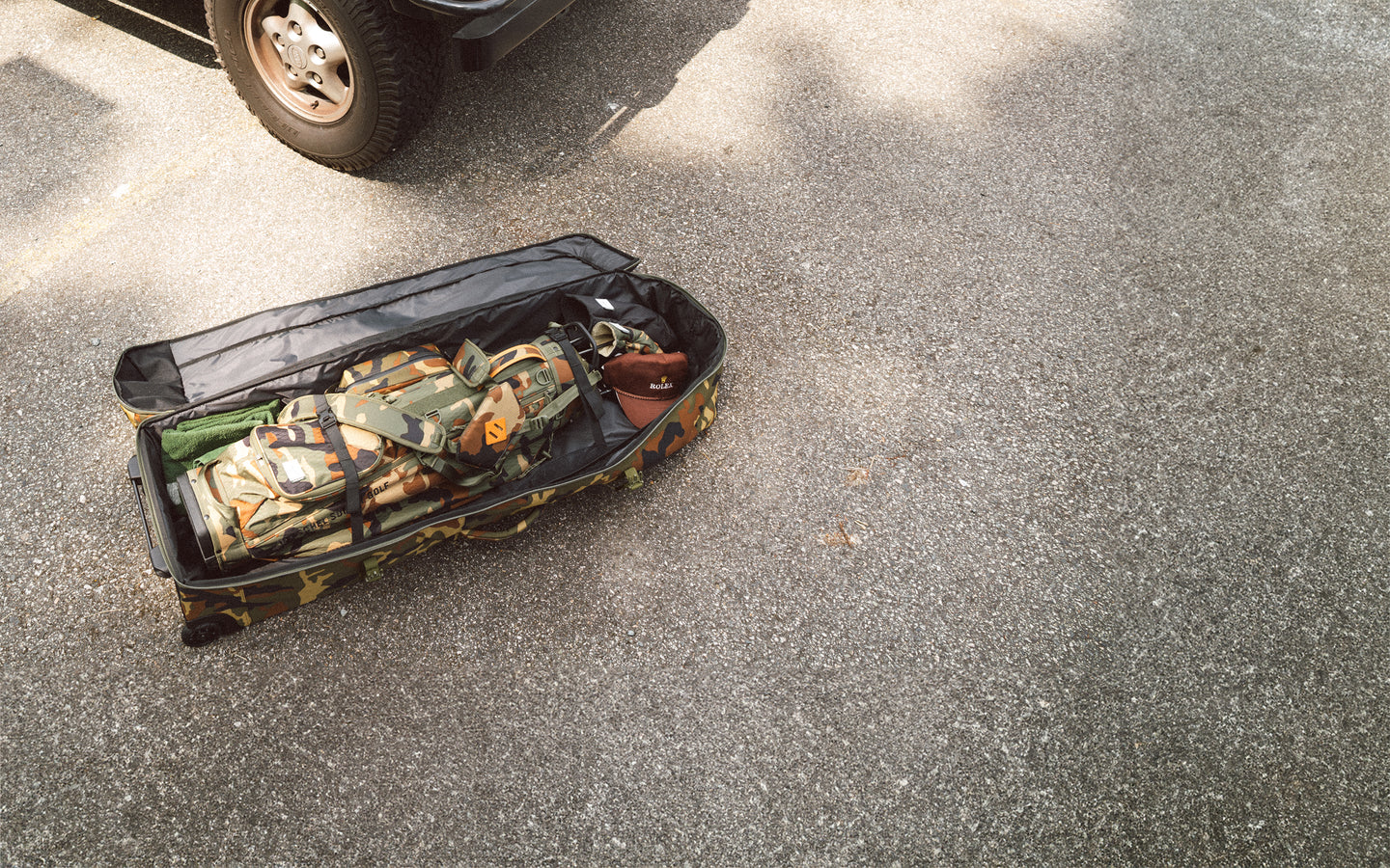 Herschel Heritage Golf Travel Wheelie Bag in Woodland Camo camo print.