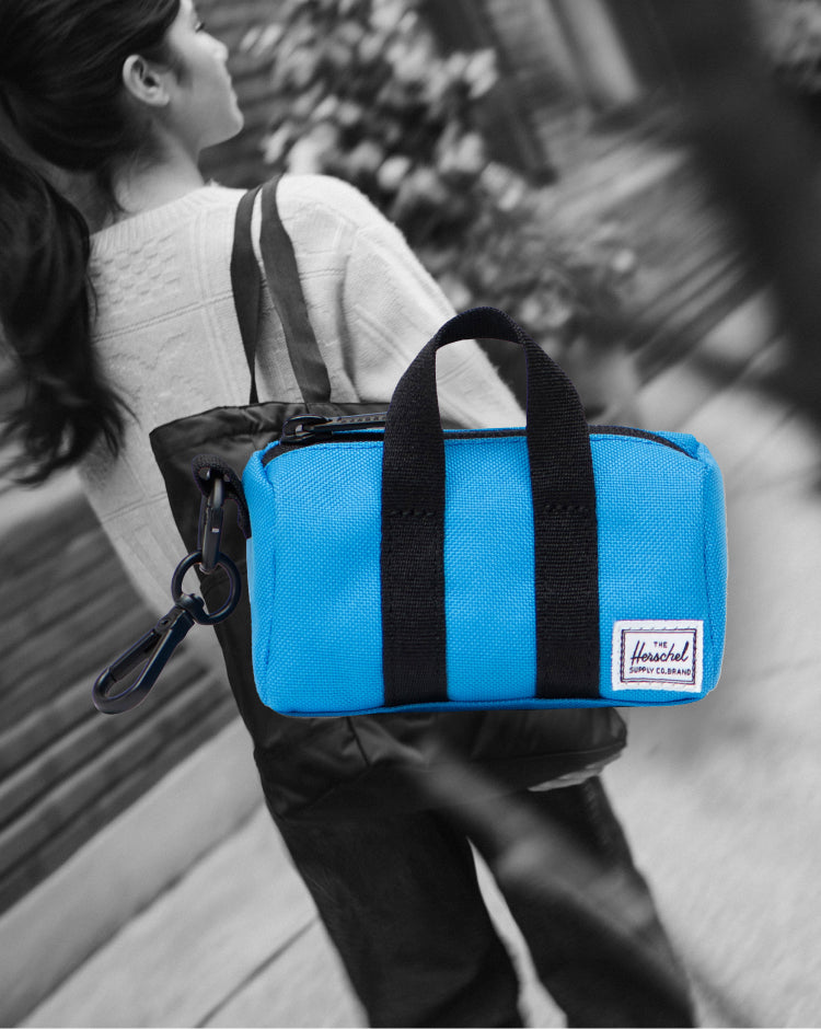 Herschel Novel Duffle Bag Charm in French Blue, a miniature bag accessory featuring a main zippered compartment and a separate shoe pocket.